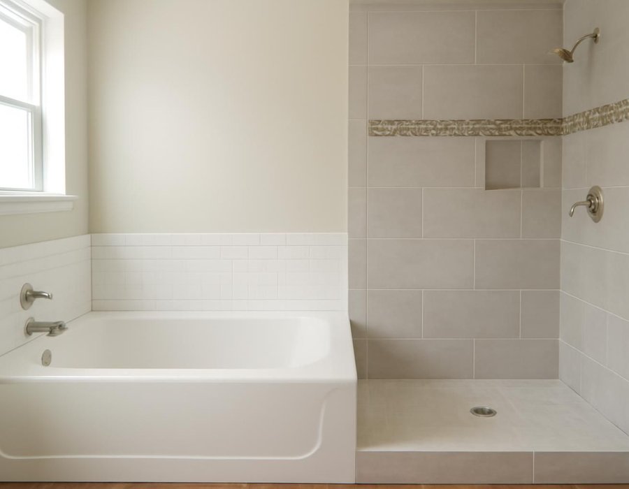 AI concept: Refreshed bathroom with a reglazed tub beside a fully remodeled bathroom with a tiled shower