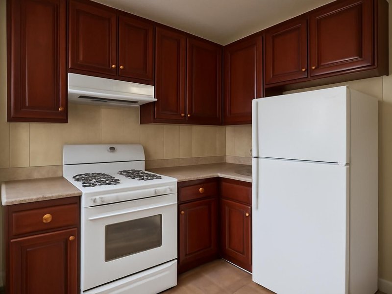 AI concept: Existing condition: dark cherry cabinets that made a small kitchen feel smaller