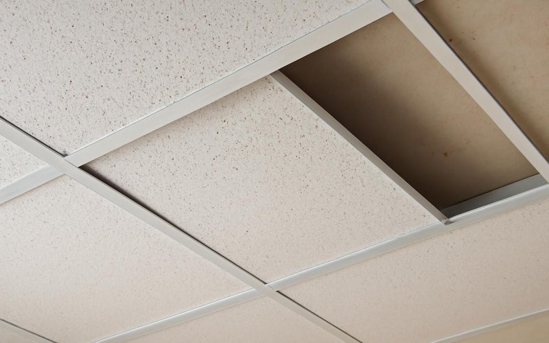 AI concept: Acoustic ceiling tile grid being installed