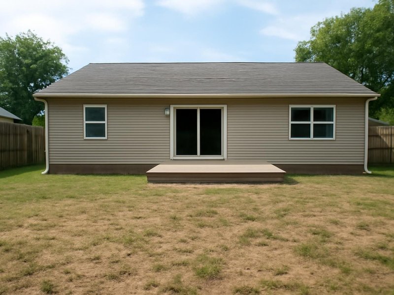 AI concept: Existing condition: bare patch of lawn behind a ranch house