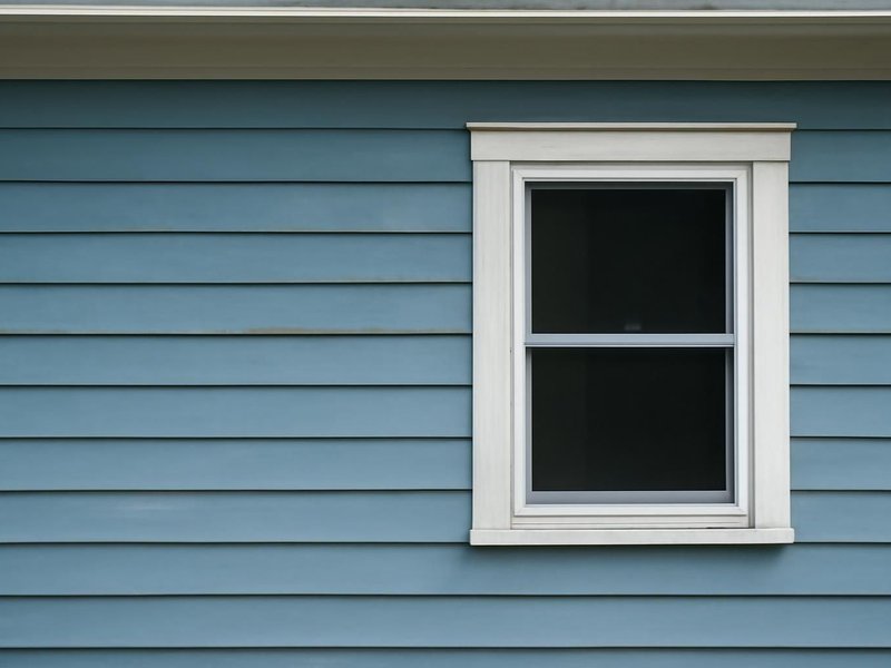 AI concept: Existing condition: faded fiber cement siding and chalky trim