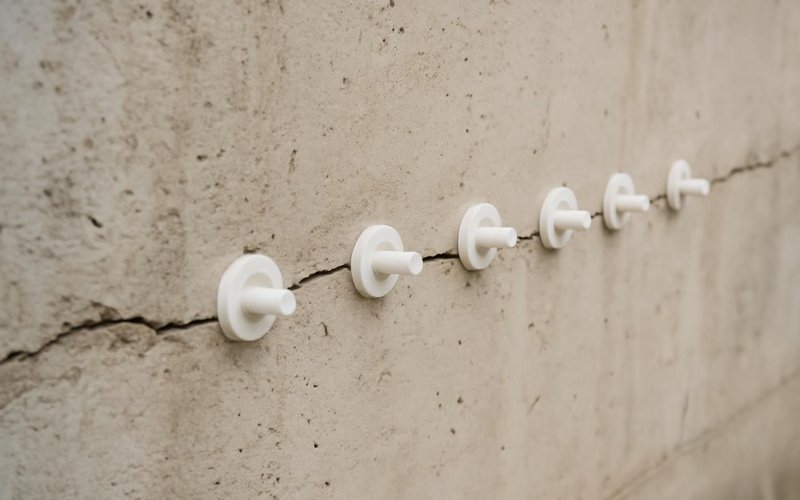 AI concept: Crack injection ports on a poured concrete wall