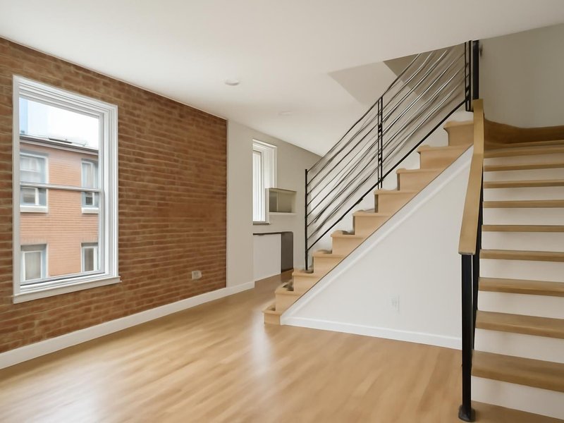 AI concept: Remodeled idea: rowhouse rebuilt with an open main floor and a new staircase