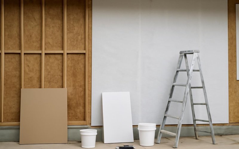 AI concept: Crew installing HardieWrap on a stripped wall