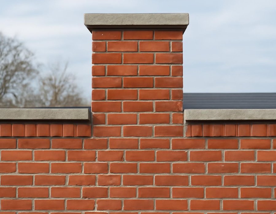 AI concept: Freshly repointed brick joints beside a rebuilt chimney top