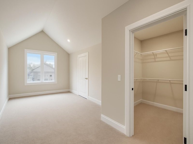After: primary suite over the garage with a vaulted ceiling and a walk-in closet