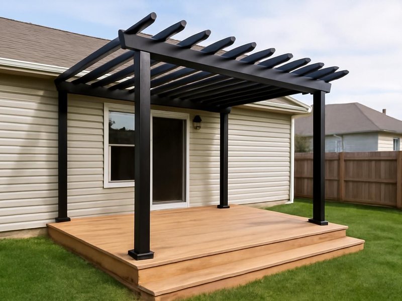 After: black aluminum pergola attached to the house over the deck