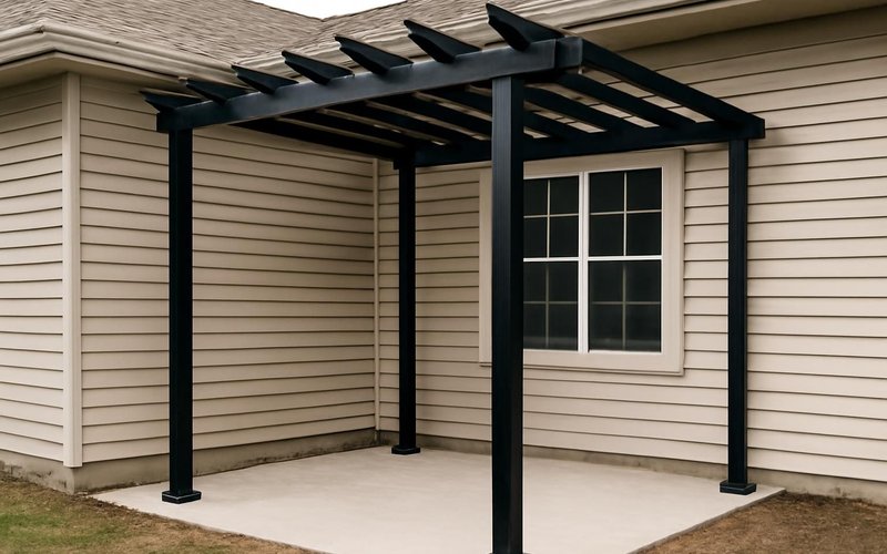 Black powder-coated aluminum pergola attached to a house