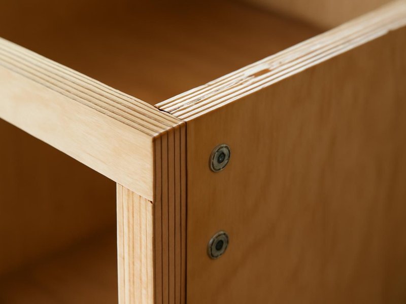 AI concept: Close-up of plywood cabinet box layered edge with firmly seated screws
