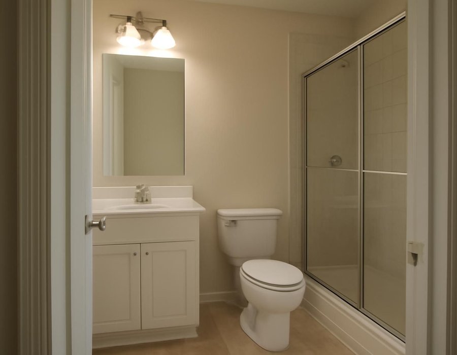 Two small bathroom floor plans, one with the toilet in place and one with it moved to free a wider shower
