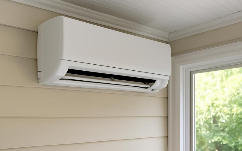 Ductless mini-split mounted on a sunroom wall