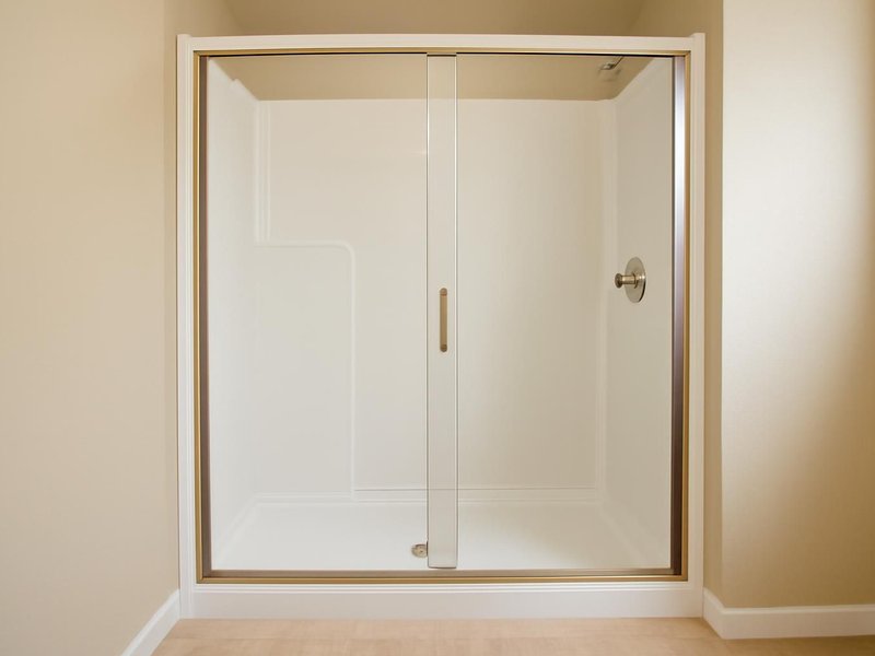 AI concept: Remodeled idea: white solid surface panel shower with a sliding glass door