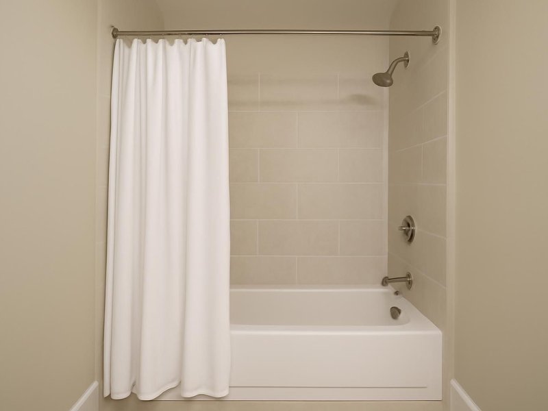 AI concept: Existing condition: tub with a curtain and a low shower head