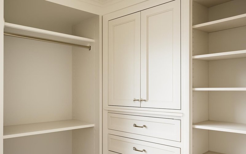 Painted wood closet cabinetry with inset doors
