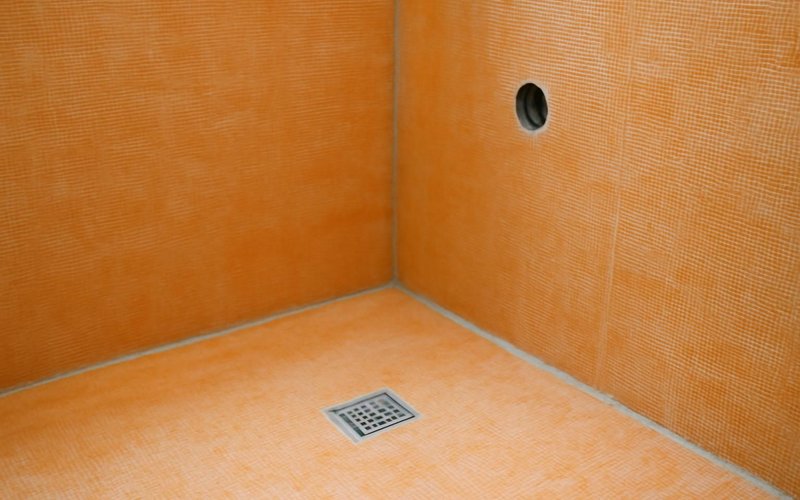 AI concept: Orange Kerdi membrane on shower walls and floor