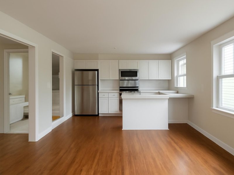 After: same split-level with a white kitchen, two tiled baths and oak floors
