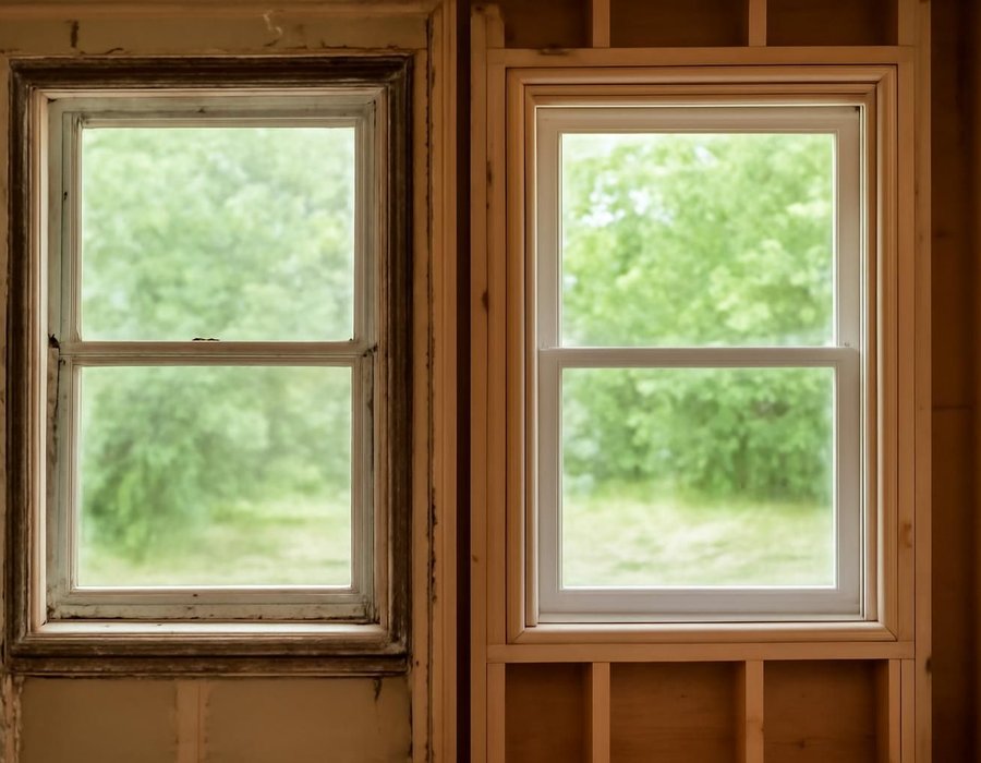 Insert window set inside an old frame next to a full-frame window installed to the studs